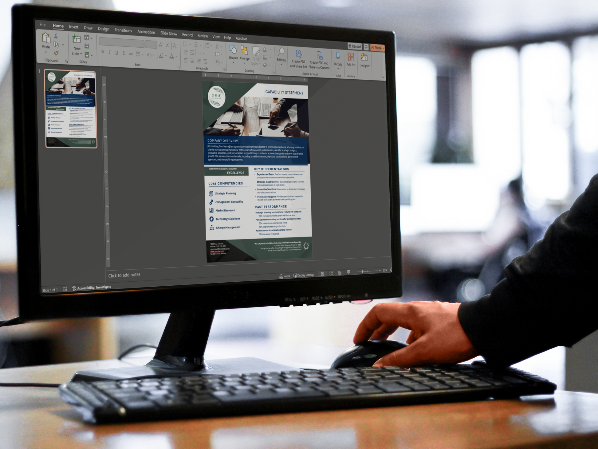 Person using a computer to edit capability statement template in PowerPoint